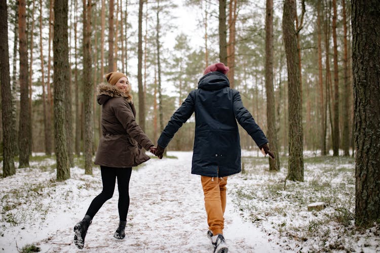 A Couple Running In The Forest 