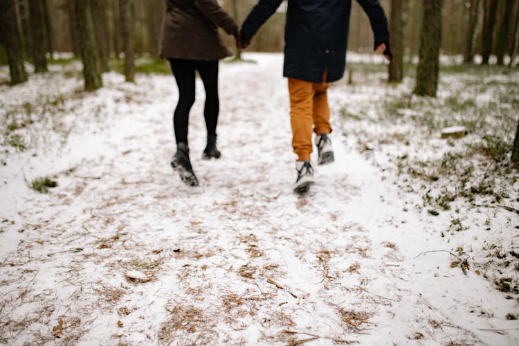 Legs Of People Walking In Forest