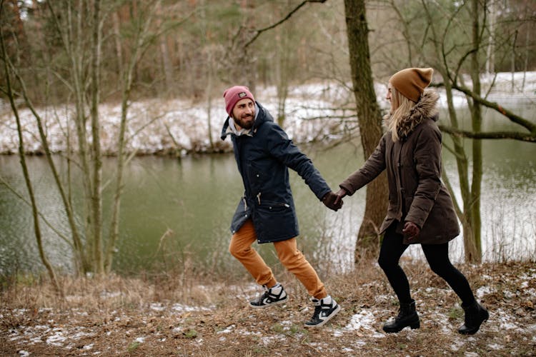 A Couple Running By The River 