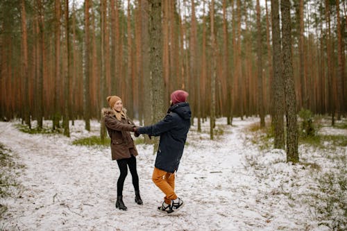 Free A Couple Holding Hands in the Woods  Stock Photo