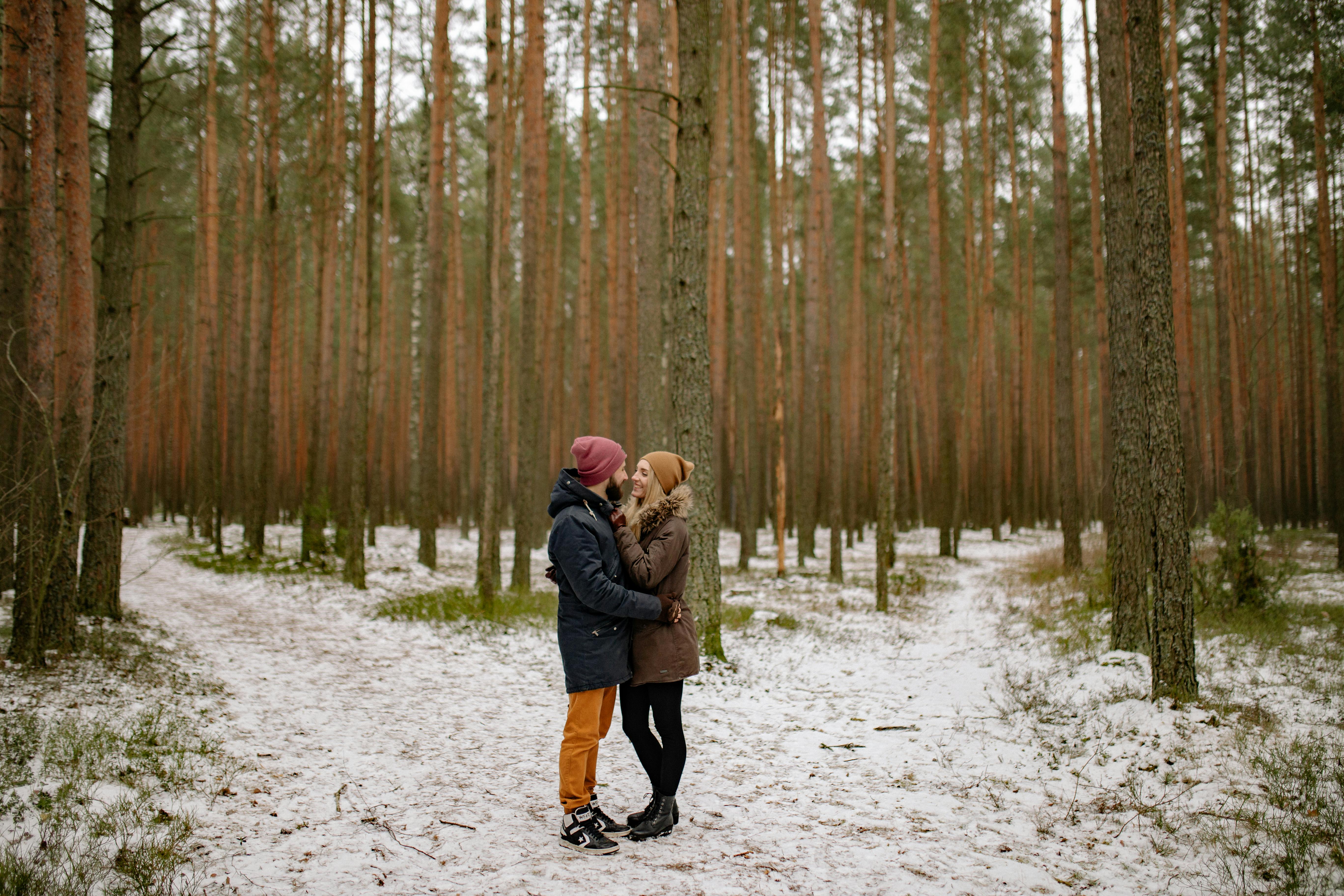 a couple standing in the forest