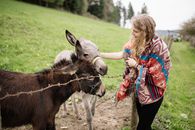 A Woman Holding a Donkey