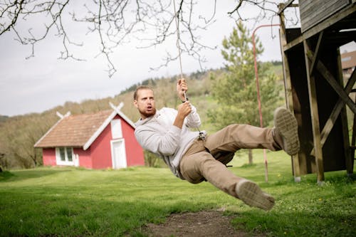 A Man Playing on a Swing