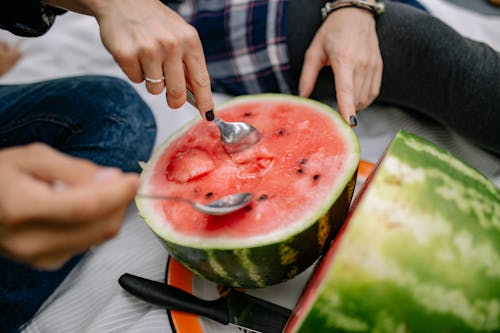 Free People Eating Watermelon Using Spoon Stock Photo