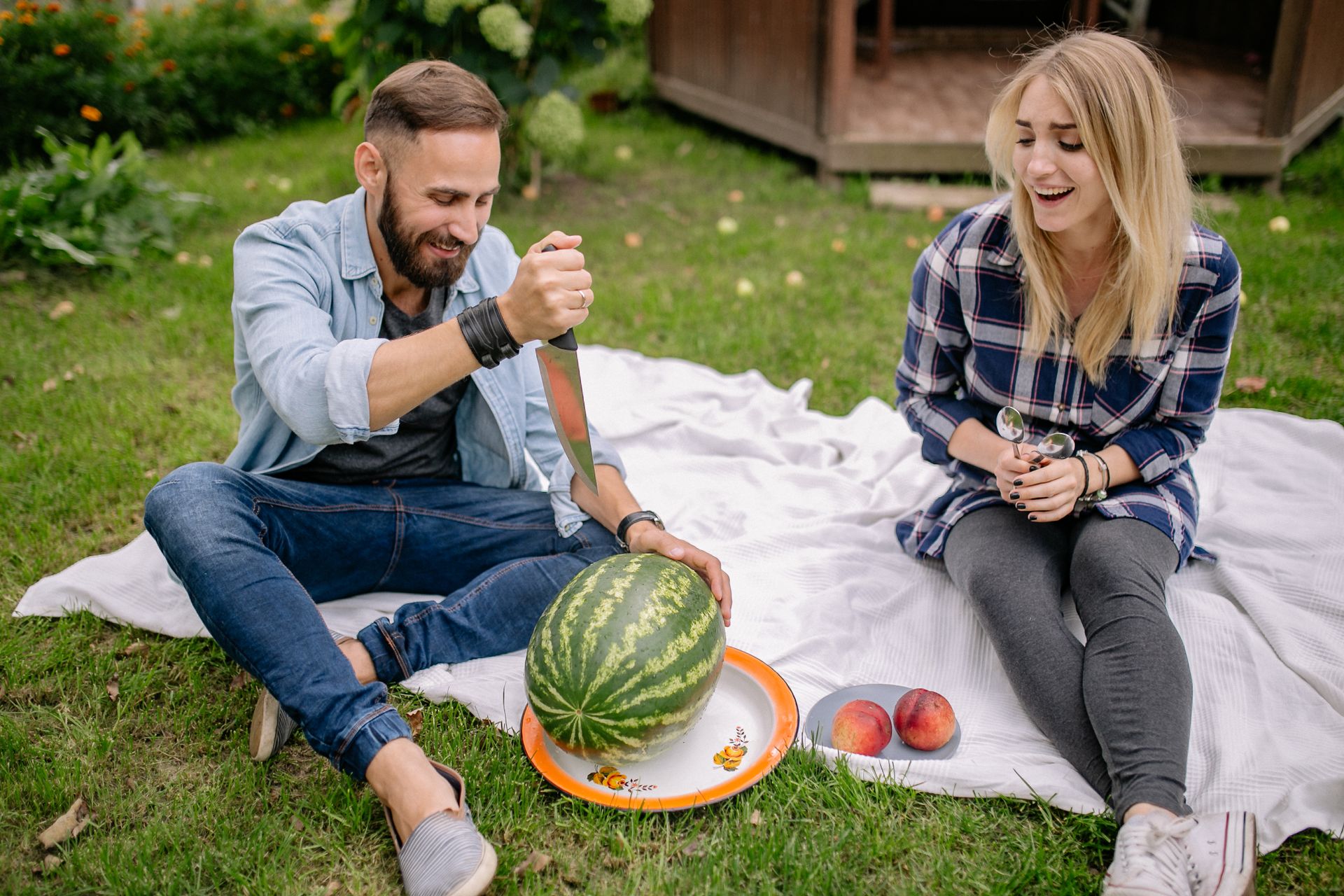 A Man Pointing a Sharp Knife on a Watermelon
