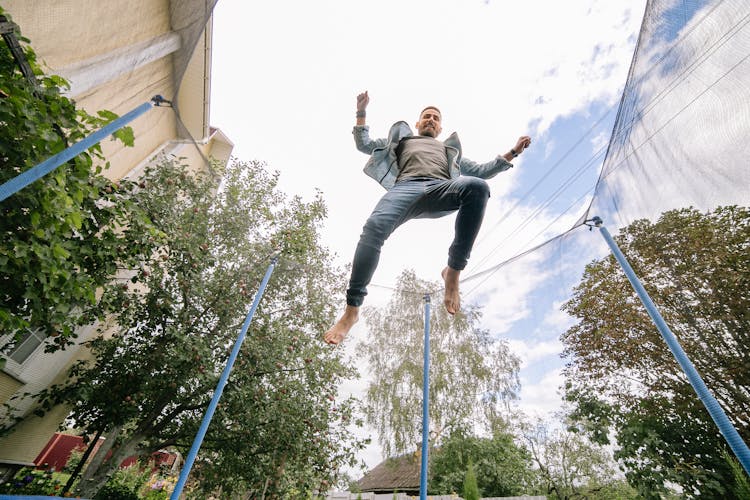 A Man Jumping On A Trampoline