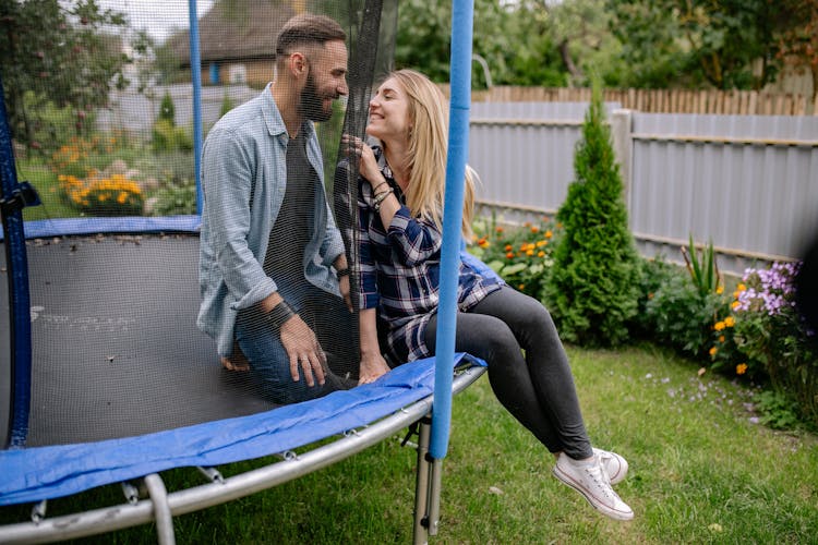 A Happy Couple On A Trampoline