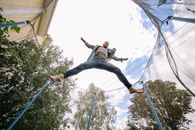 A Man Midair with His Legs Apart