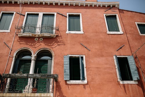 Brown Concrete House with White Wooden Windows