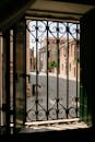 Black Metal Gate Near White Concrete Building