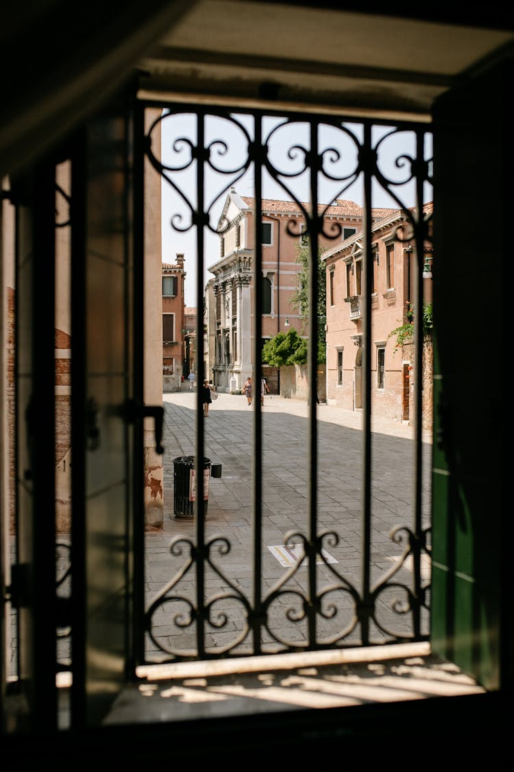 View of Street Through Barred Window From House Inside