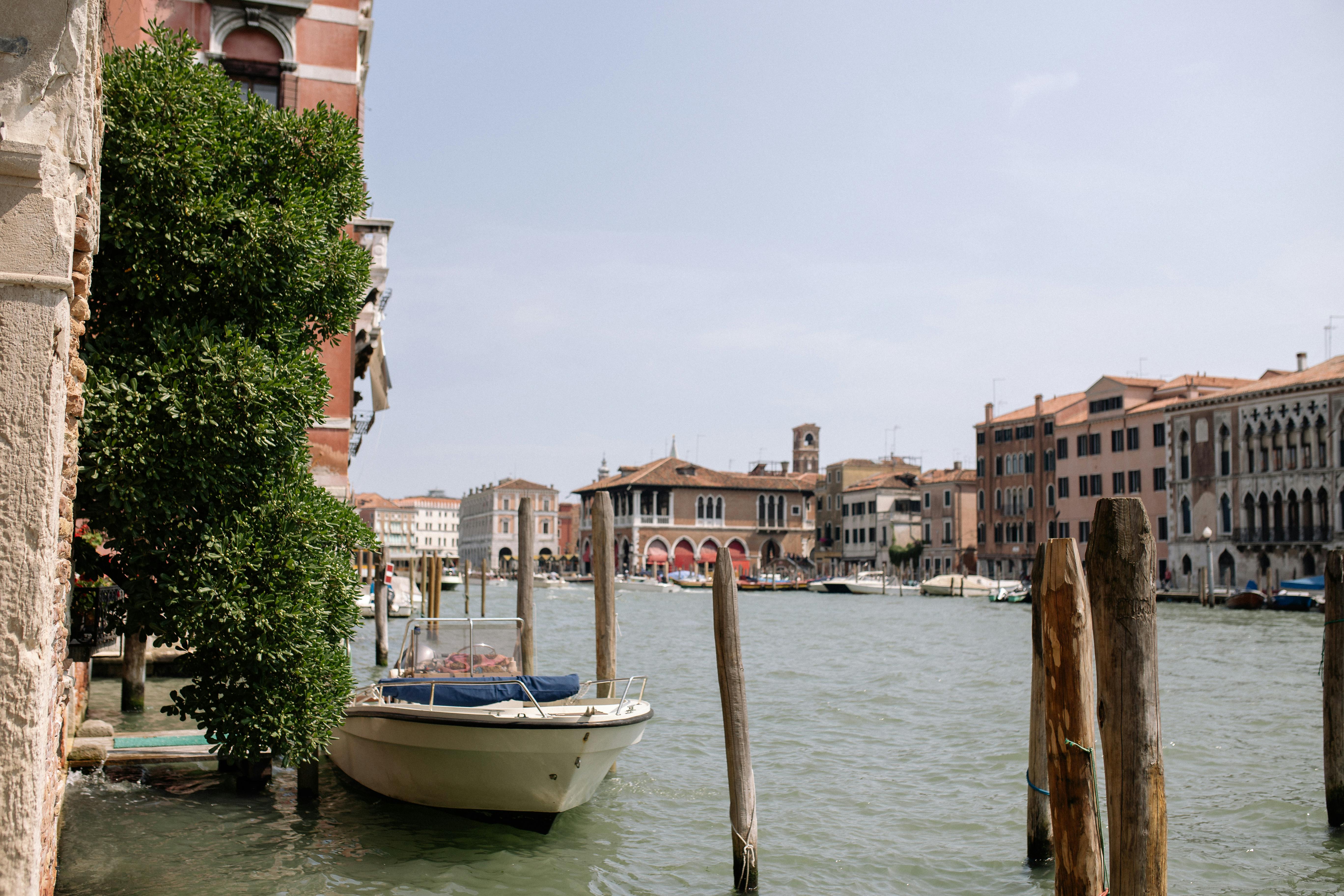 boat moored on the side of a canal in venice