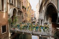 Bridge Between Building Covered in Flowers in Venice, Italy