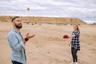 Smiling Man and Woman in Desert Having Fun