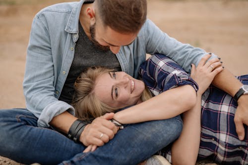 Woman Lying on Her Partners Lap and Smiling 