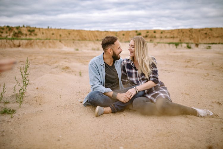 Couple Sitting On The Sand