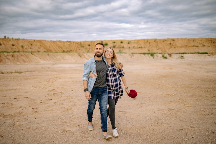 Couple Walking With Arms Around Each Other 