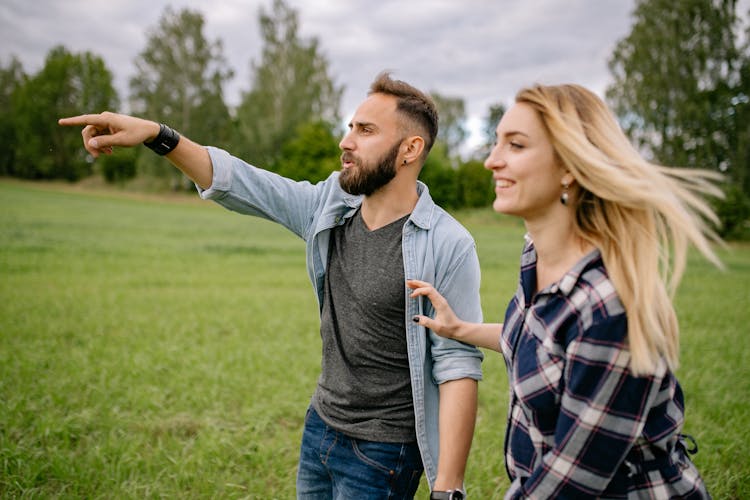 Man And Woman In A Green Field