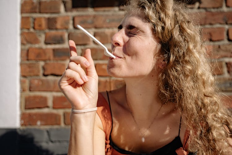 Woman Holding Fork With Her Mouth 