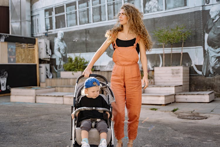 Woman In Dungarees With Child In A Pram