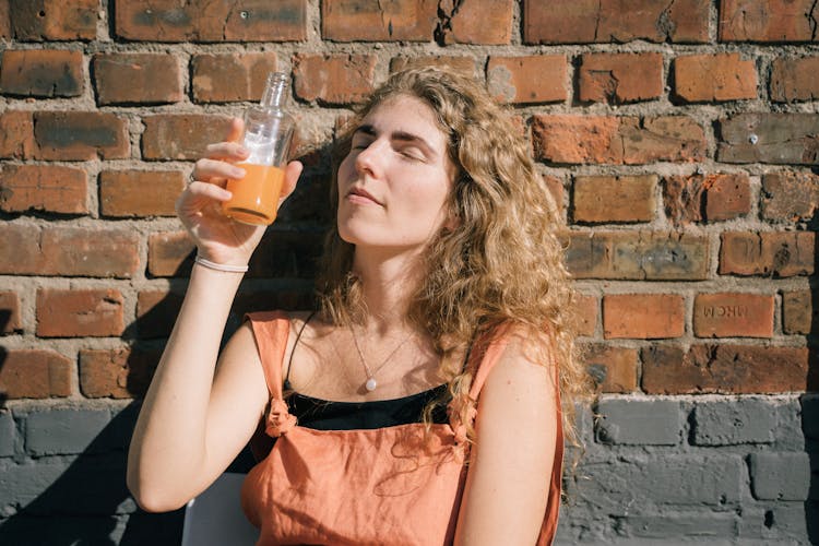 Woman Drinking Juice From A Bottle 