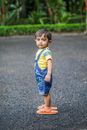 Little Boy Wearing Too Big Flip-flops