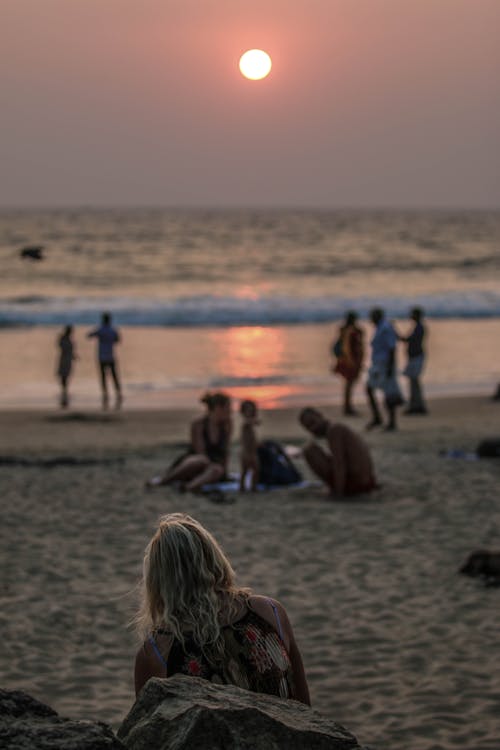 Free People on the Beach during Sunset Stock Photo