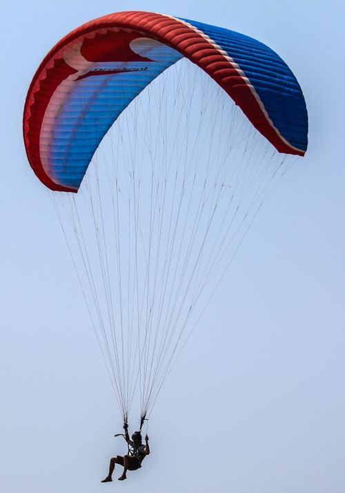 Free Experience the thrill of paragliding in the scenic skies of Varkala, India. Stock Photo