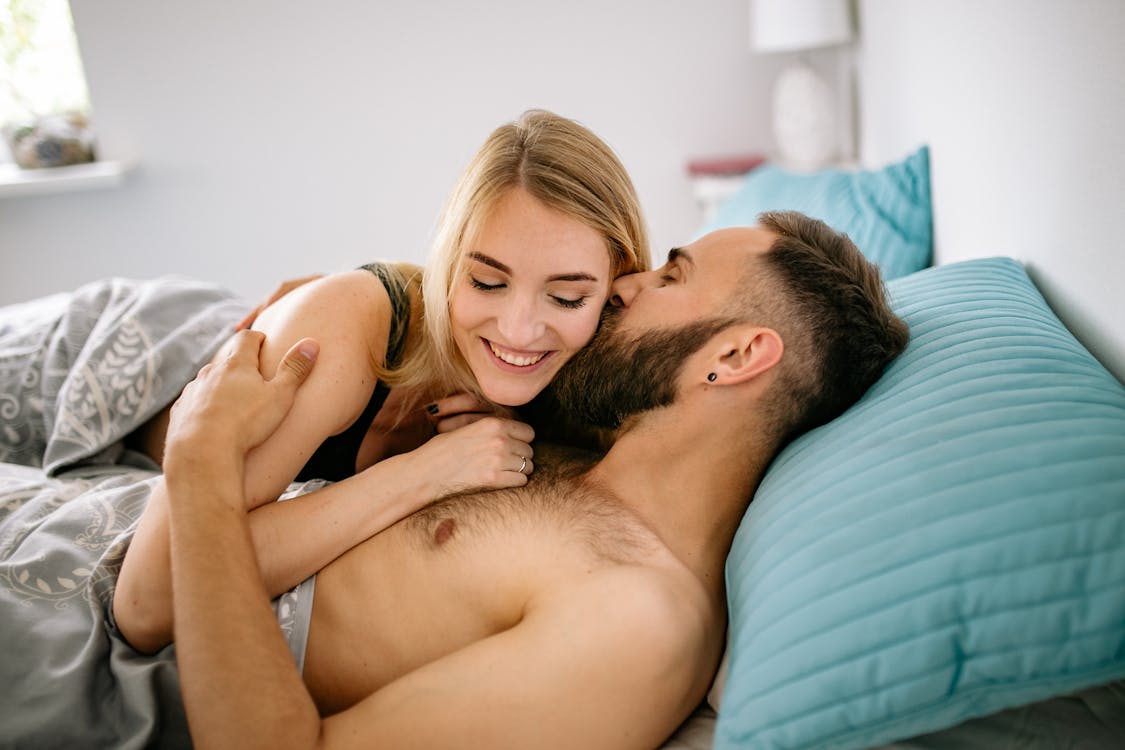 Free Man and Woman Lying on Bed Stock Photo
