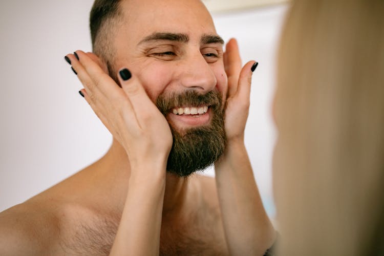 Woman Holding Hands On Face Of Man