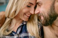 Man and Woman Smiling While Kissing