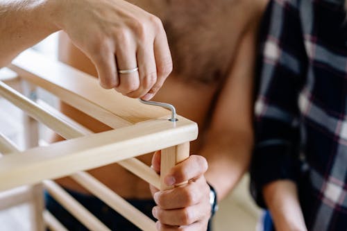 Close-up of Married Man Assembling Furniture