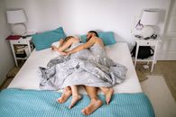 Woman in Gray Dress Lying on Bed