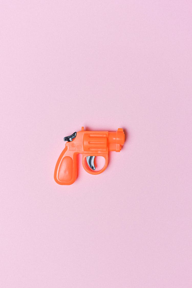 Red Revolver For Game On Pink Background