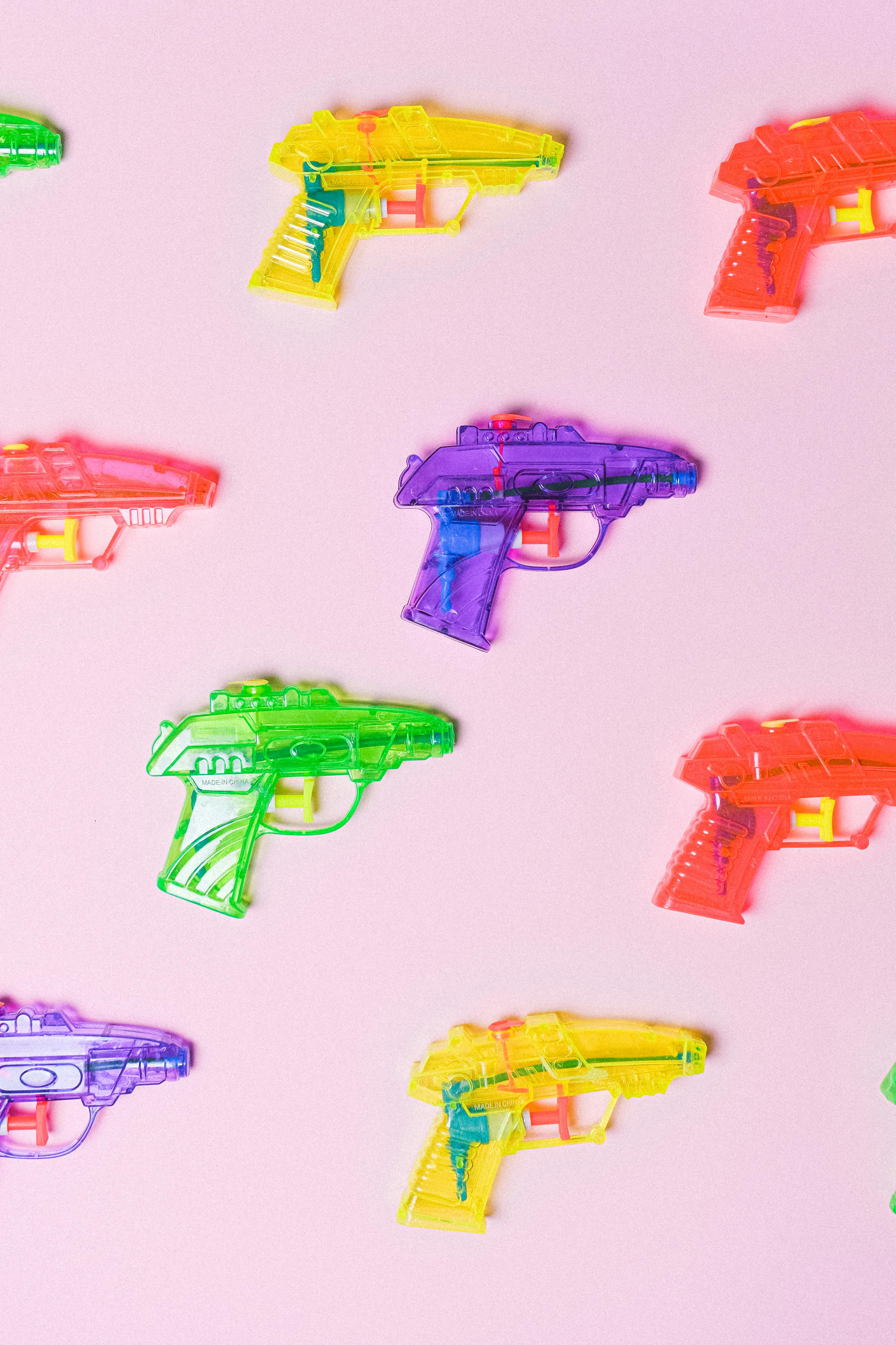 assortment of colorful plastic guns for pretend fight