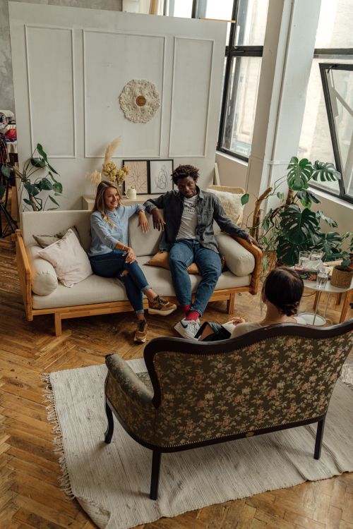 Free A couple in a counseling session with a therapist in a stylish, well-lit loft space. Stock Photo