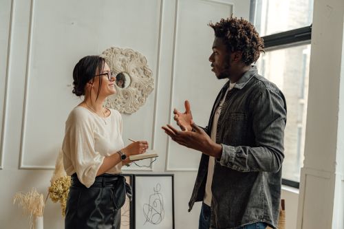 Free A man and woman engaging in a professional consultation in a stylish office setting, highlighting collaboration. Stock Photo