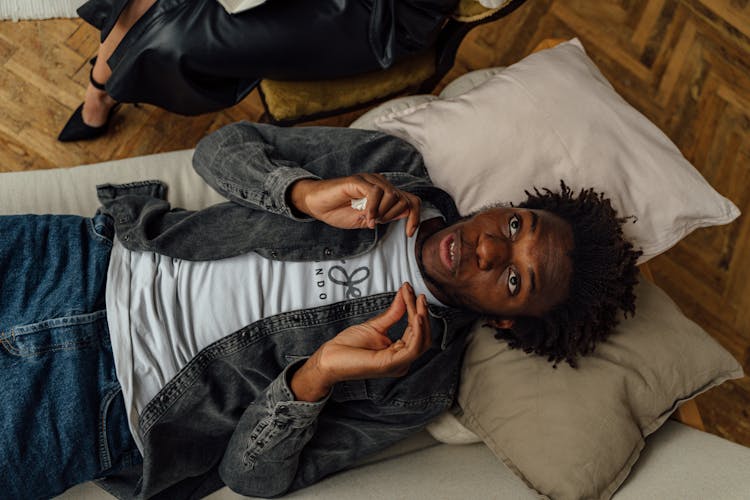 Top View Of A Man Lying Down On A Couch