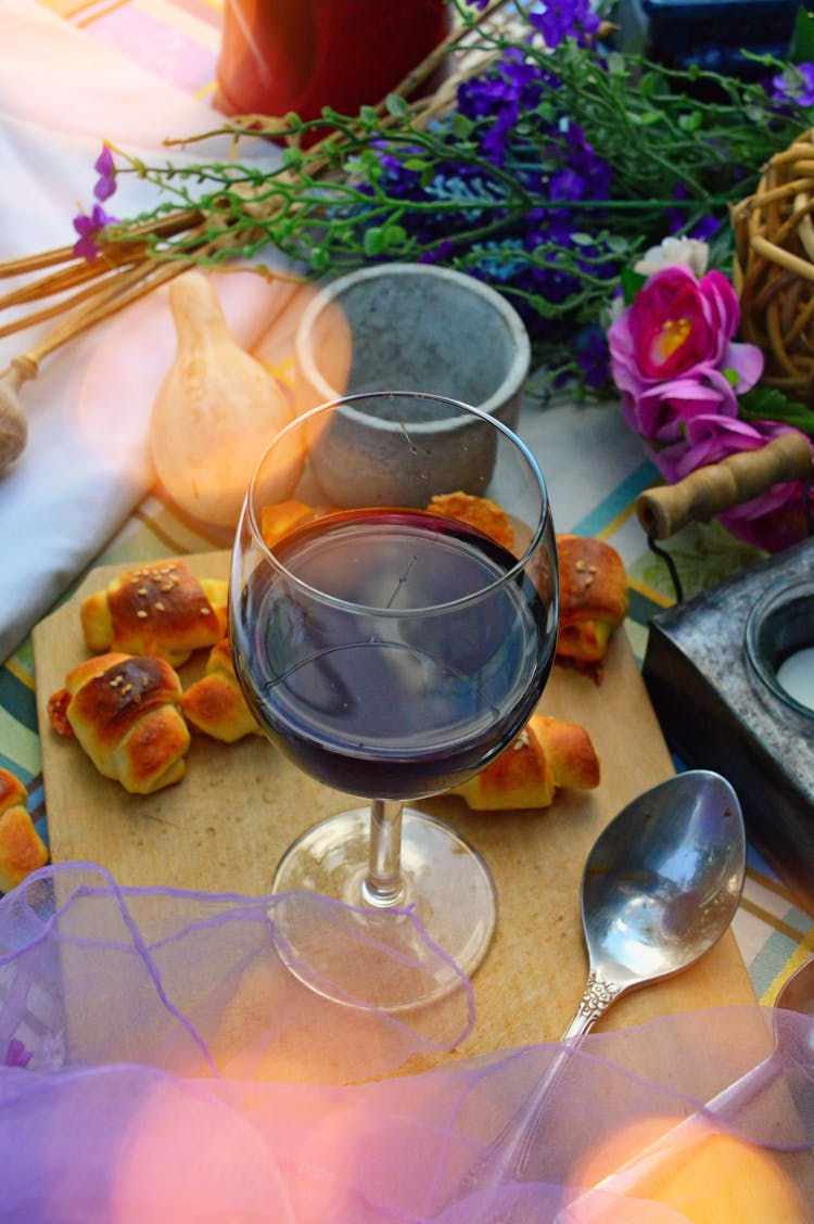 Glass Of Wine Flowers On Table