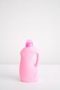 Plastic bottle of fabric softener chemical liquid for washing and household chores against white background
