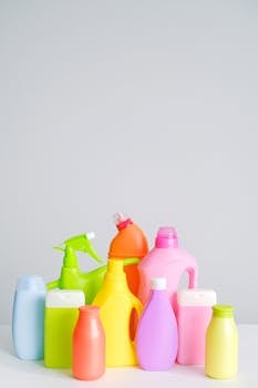Vibrant assortment of cleaning bottles arranged on a white background, ideal for home cleaning themes.