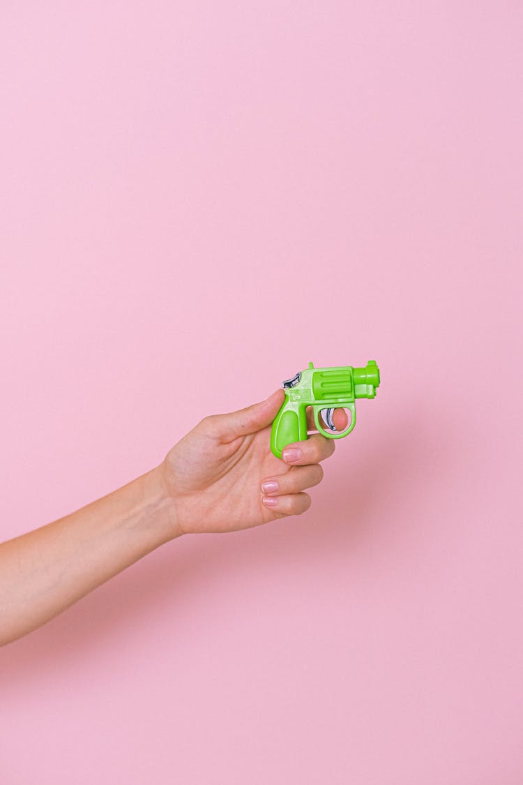 Crop Hand With Plastic Pistol