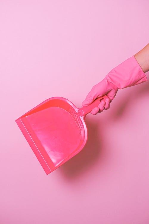Free Crop faceless person with pink dust shovel Stock Photo