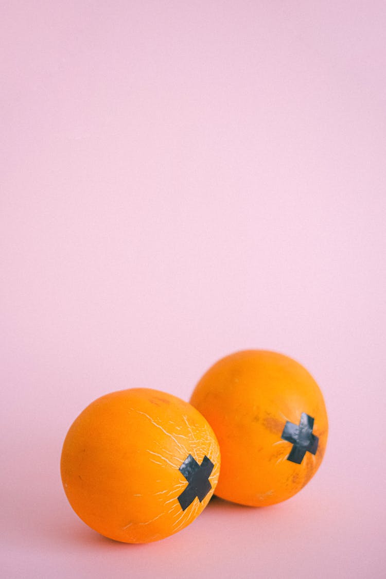 Ripe Oranges With Black Tape Crosses