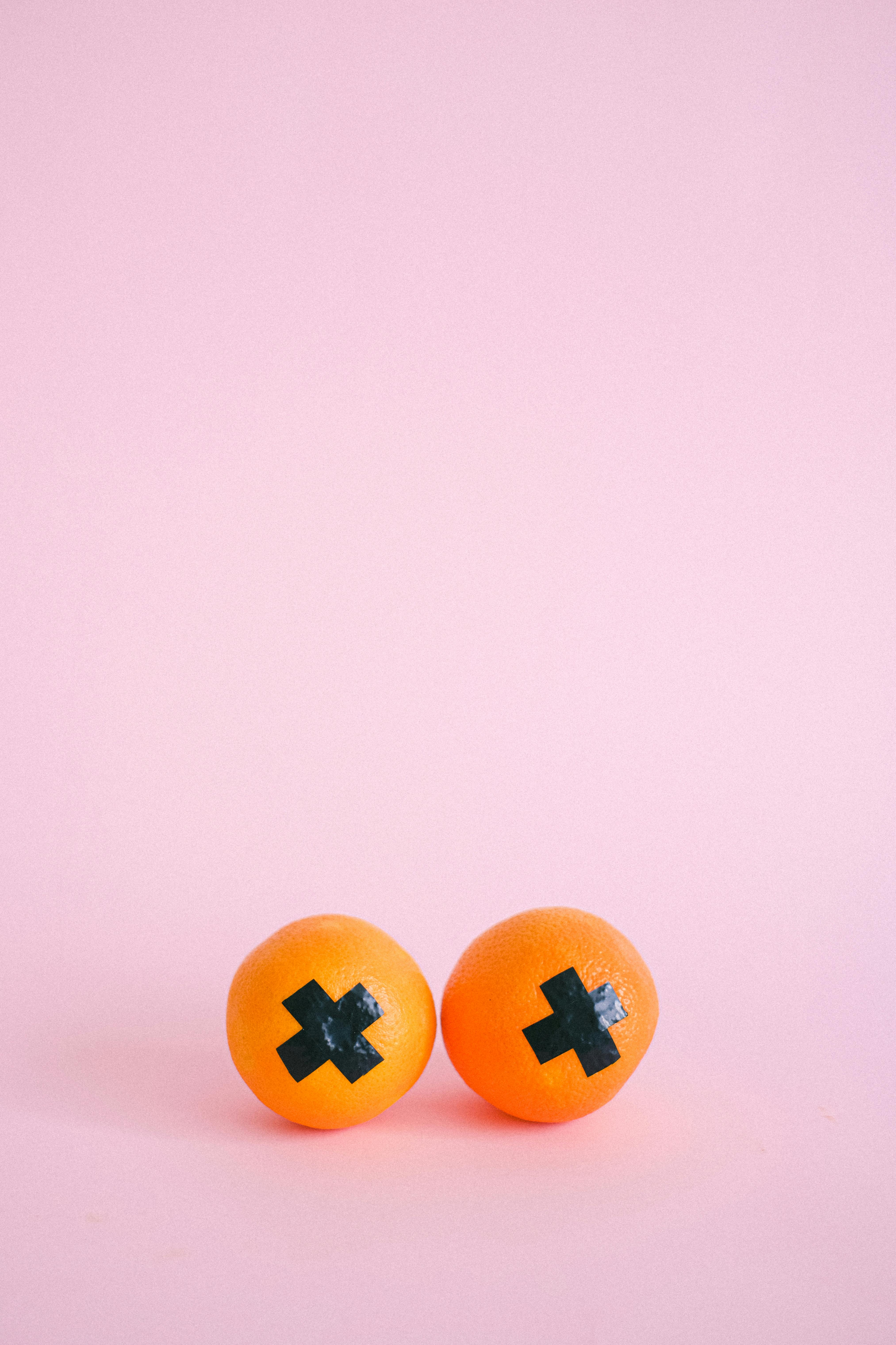 ripe melons with black cross on pink background