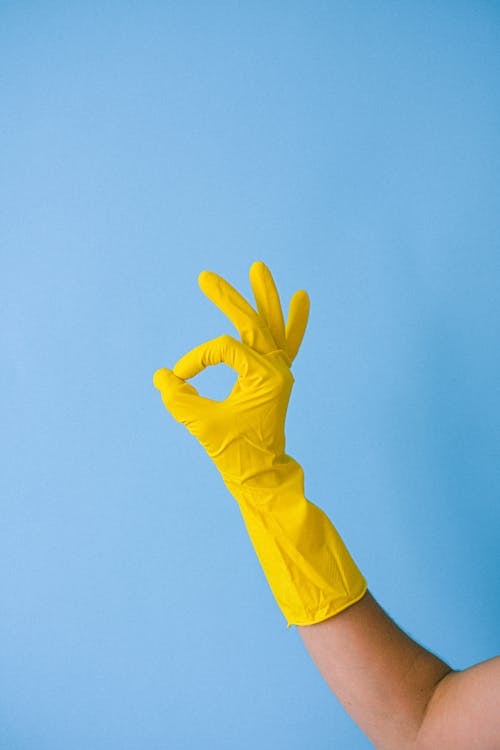 Free Crop faceless person in rubber glove showing okay gesture Stock Photo