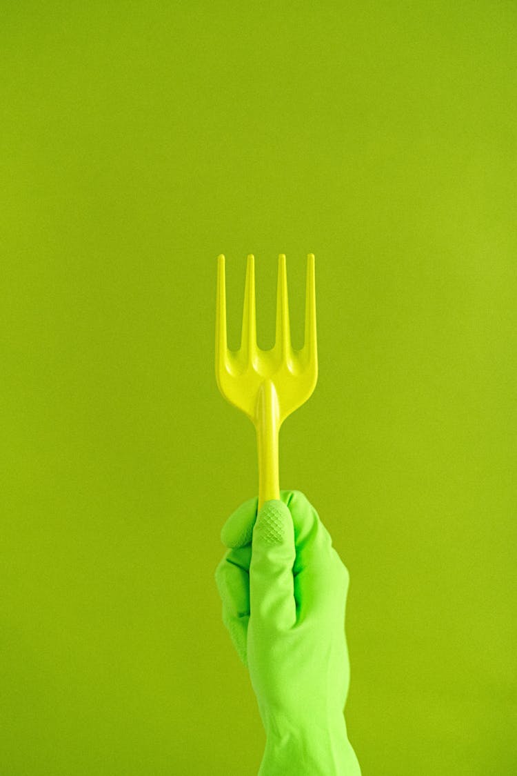 Crop Faceless Gardener Showing Hand Rake