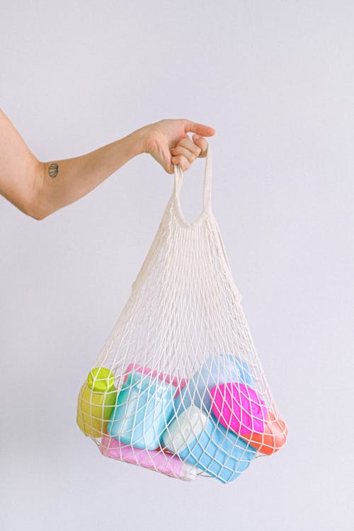 Woman with string bag with plastic containers