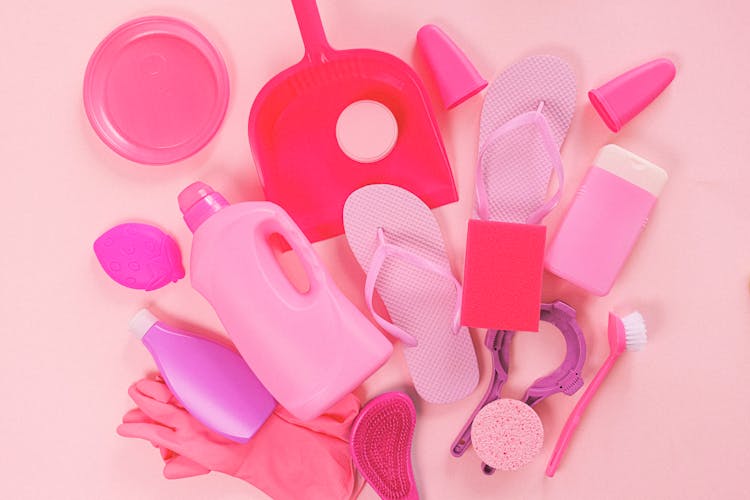 Set Of Cleaning Supplies On Pink Background