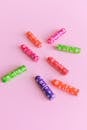 From above composition of female tampons in multicolored plastic unit pack arranged on light pink background